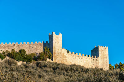 Low angle view of fort against blue sky