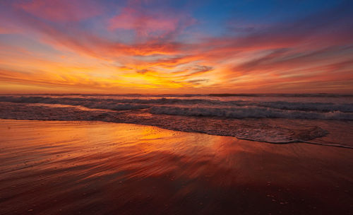 Scenic view of sea against orange sky