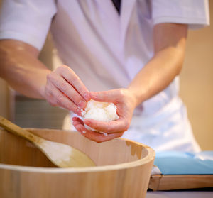 Midsection of man preparing food