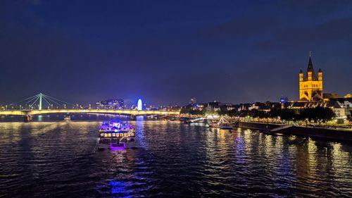 Bridge over river in city at night