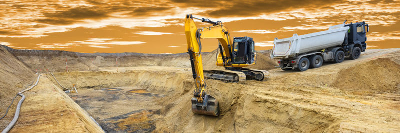 Excavator is working and digging at construction site