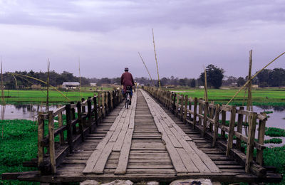 Rear view of man walking on water