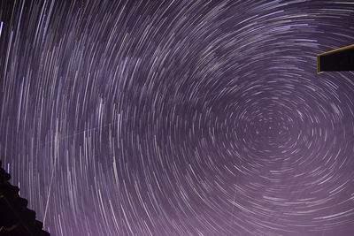 Low angle view of fireworks against sky at night