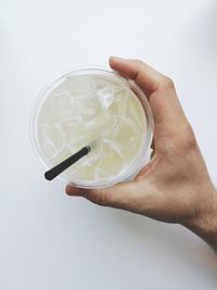 Close-up of hand holding over white background