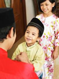 Portrait of happy father and daughter at home