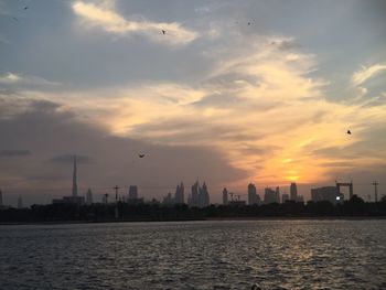Scenic view of river against sky at sunset