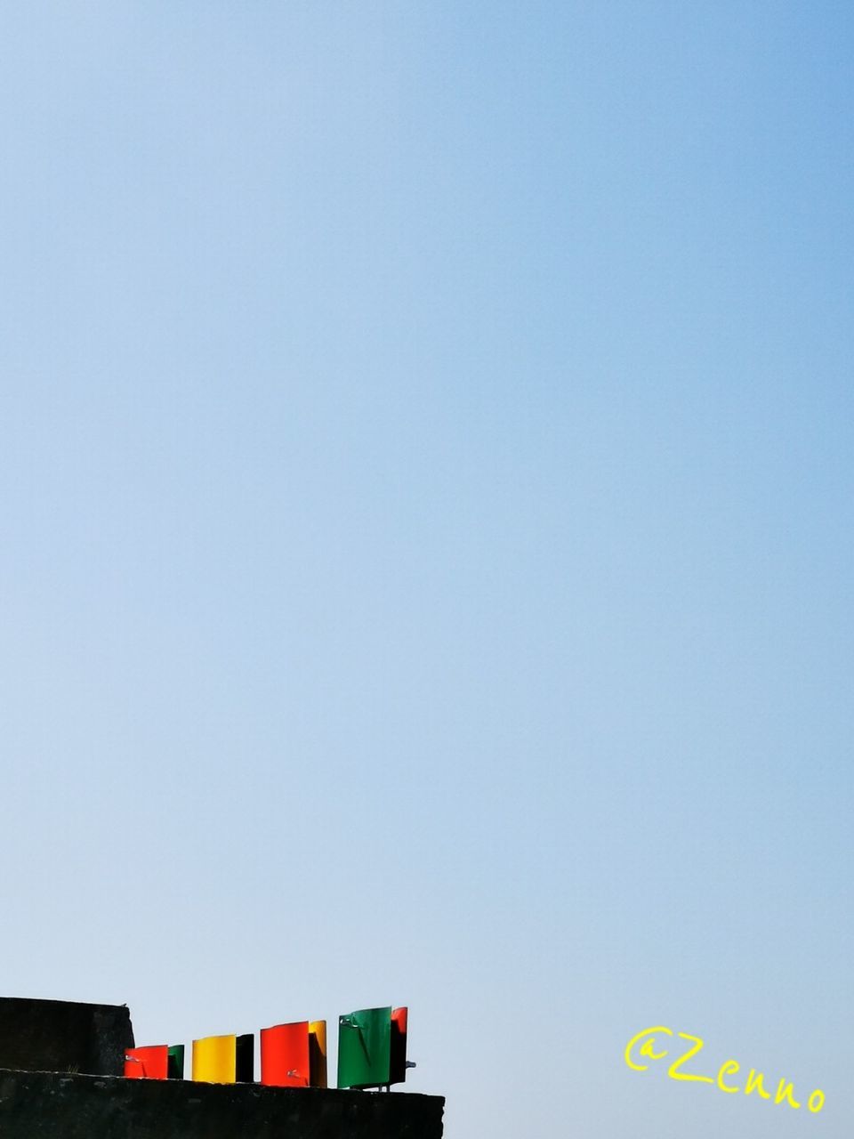 sky, multi colored, copy space, no people, low angle view, clear sky, blue, nature, built structure, architecture, day, building exterior, outdoors, building, sign, communication, high section, side by side, balloon, hanging