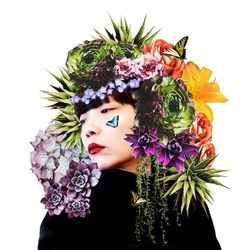 Close-up of young woman with pink roses against white background