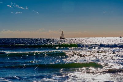 Sailboat in sea against sky