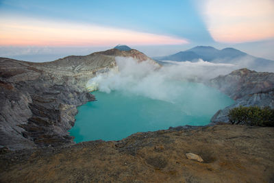 High angle view of hot spring by rock formation