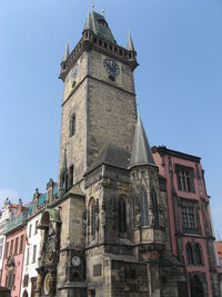 Low angle view of prague astronomical clock against clear blue sky