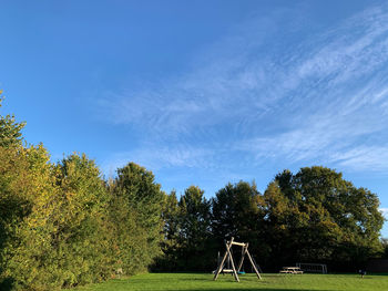 Trees on field against sky