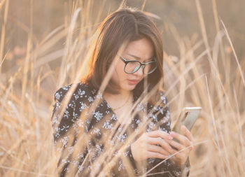 Young woman using mobile phone outdoors