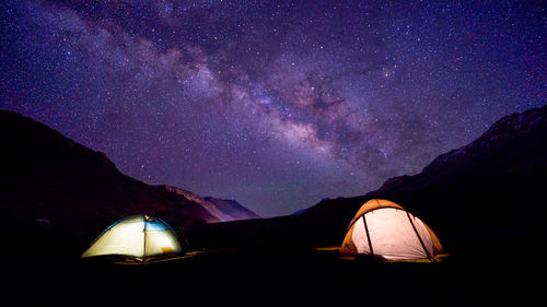 Illuminated tent against sky at night