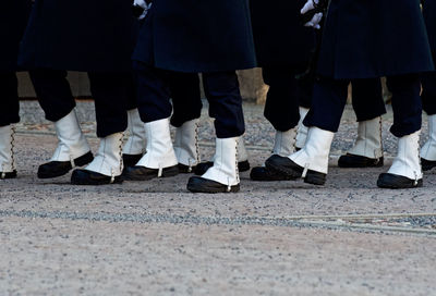 Low section of people standing on street