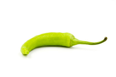 Close-up of green chili pepper against white background