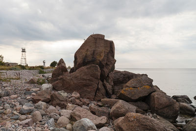 Rocks on beach against sky
