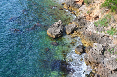 High angle view of rocks by sea