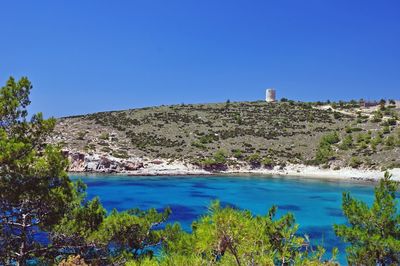 Scenic view of calm sea against clear blue sky