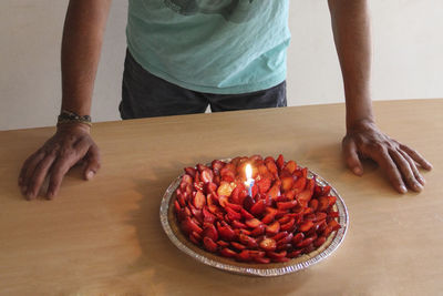 Low section of man standing on table