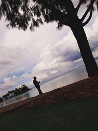 Man standing by sea against sky