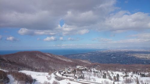 Scenic view of mountains against cloudy sky