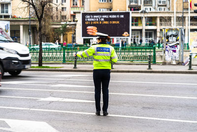 Full length rear view of man standing on street