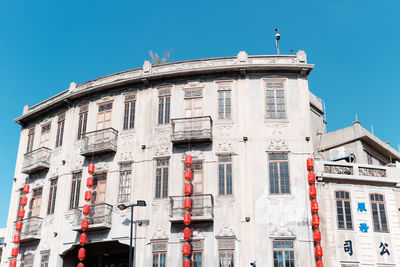 Low angle view of building against clear blue sky