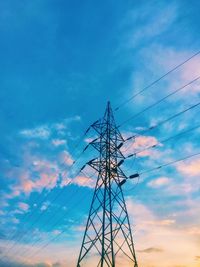 Low angle view of electricity pylon against sky