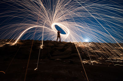 Low angle view of silhouette woman standing at night