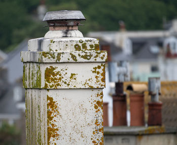 Close-up of rusty metallic structure against wall