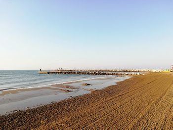 Scenic view of beach against clear sky