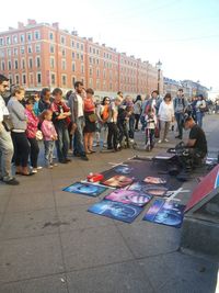 People in town square against sky