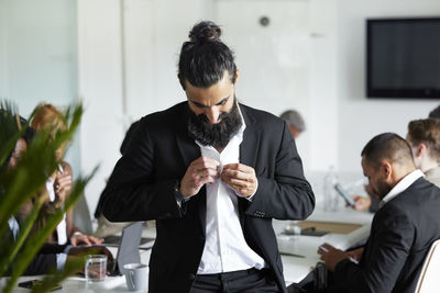 Businessman standing in boardroom