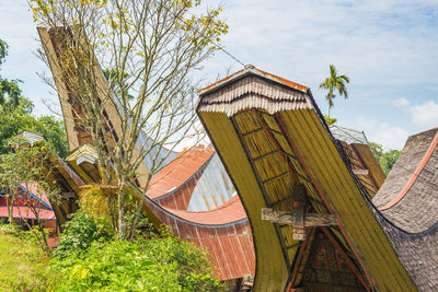 Built structure with trees against sky