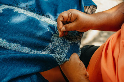 Midsection of man holding hands