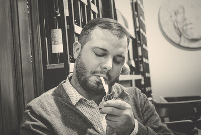 Portrait of young man smoking cigarette