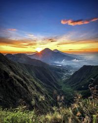 Scenic view of mountains against sky during sunset