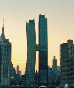 Modern buildings against clear sky during sunset