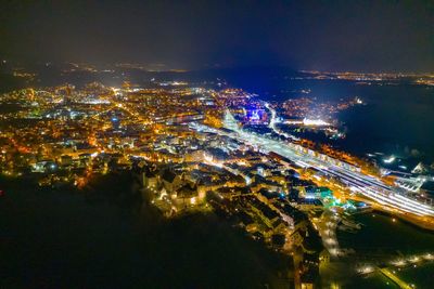 High angle view of illuminated city buildings at night