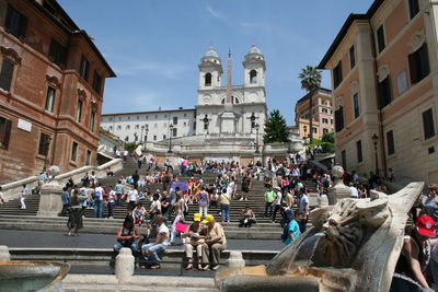 Low angle view of people on spanish steps leading towards trinita dei monti