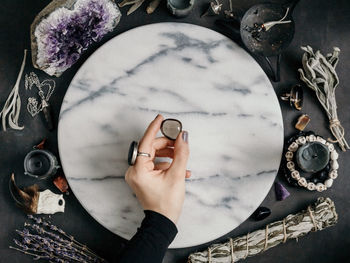 Cropped image of fortune teller with various objects on table