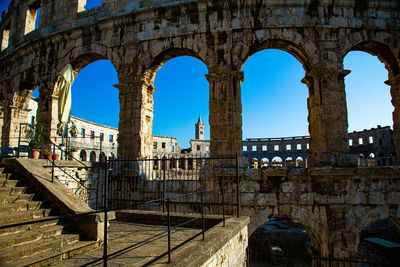 Sand arches of pula, with stairs and church in the background