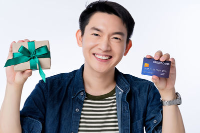 Portrait of smiling man standing against white background