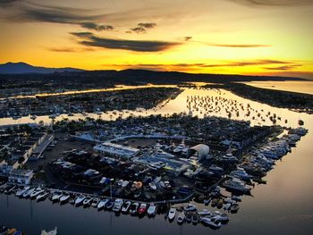 High angle view of marina and buildings at sunset