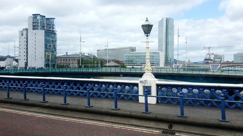 View of cityscape against cloudy sky