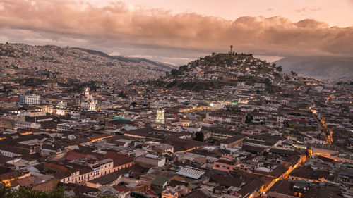 High angle view of cityscape against cloudy sky