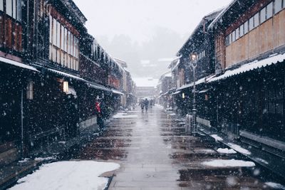 Snow covered city against sky