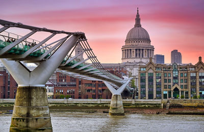 View of bridge over river against buildings