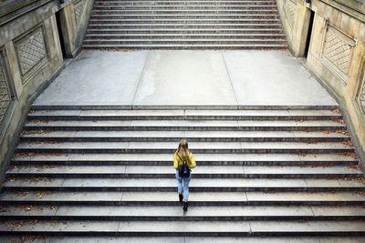 High angle view of woman climbing steps at park